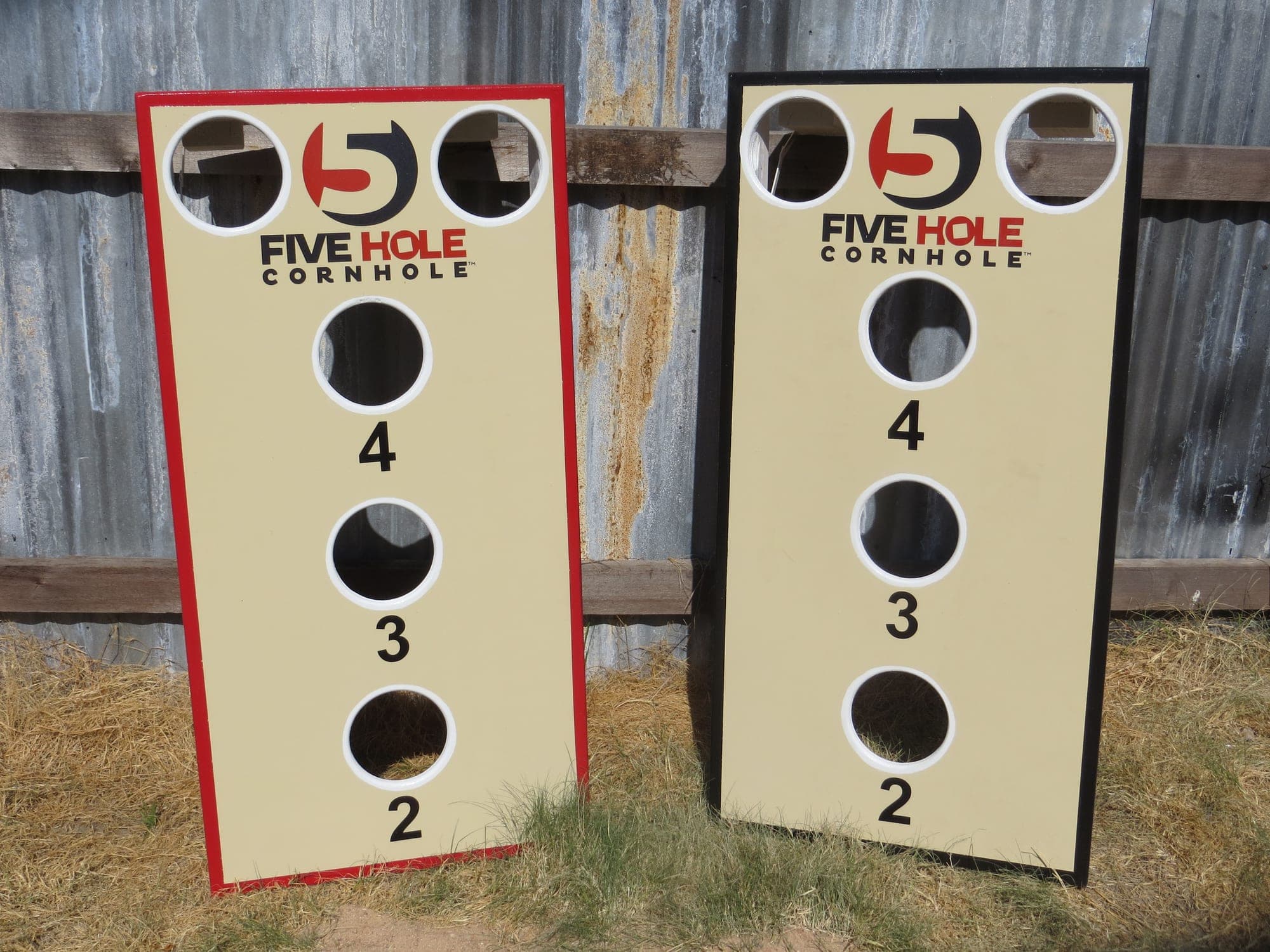 Two 5-hole cornhole boards showing the 2, 3 and 4 point center holes and corner holes