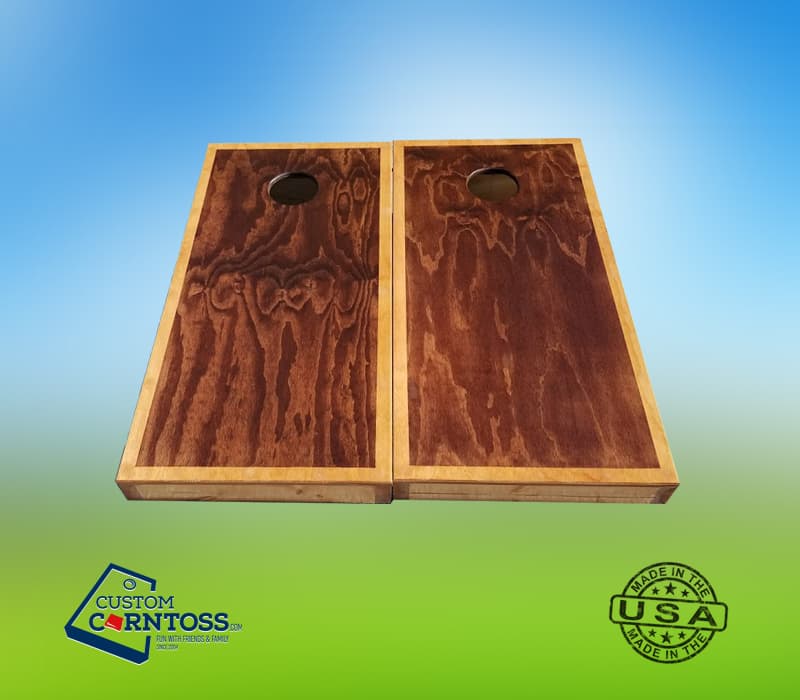Pair of stained wood cornhole boards with a dark stain top and lighter trim